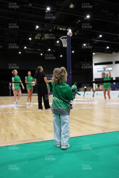 240525 - Cardiff Dragons v Loughborough Lightning - Netball Super League - A young fan watches the players warm up