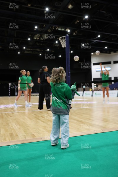 240525 - Cardiff Dragons v Loughborough Lightning - Netball Super League - A young fan watches the players warm up