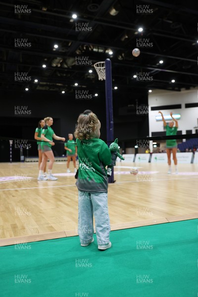 240525 - Cardiff Dragons v Loughborough Lightning - Netball Super League - A young fan watches the players warm up
