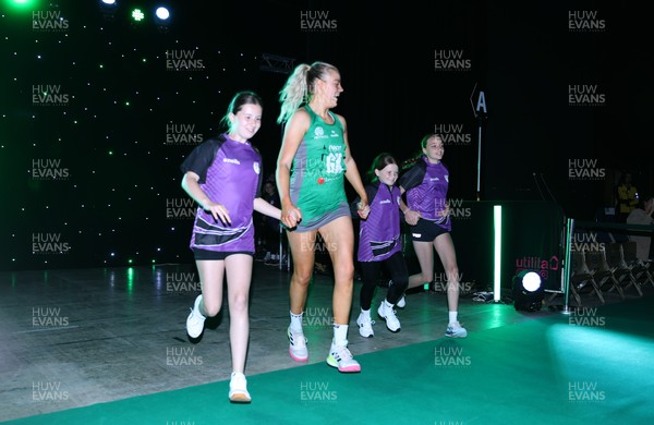 240525 - Cardiff Dragons v Loughborough Lightning - Netball Super League - Alex Johnson of Cardiff Dragons with mascots