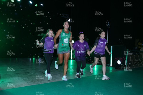 240525 - Cardiff Dragons v Loughborough Lightning - Netball Super League - Elle McDonald of Cardiff Dragons with mascots