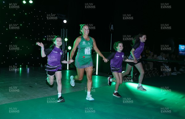 240525 - Cardiff Dragons v Loughborough Lightning - Netball Super League - Bethan Dyke of Cardiff Dragons with mascots
