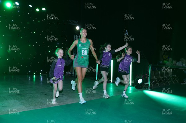 240525 - Cardiff Dragons v Loughborough Lightning - Netball Super League - Phillipa Yarranton of Cardiff Dragons with mascots