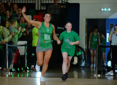 190424 - Cardiff Dragons v Surrey Storm - Vitality Netball SuperLeague - Elle McDonald of Cardiff Dragons walking out with the mascot