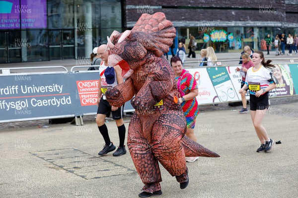 011023 - Principality Building Society Cardiff Half Marathon 2023 - Cardiff Bay - Runner dressed as dinosaur