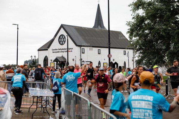 011023 - Principality Building Society Cardiff Half Marathon 2023 - Cardiff Bay - Extra Miler volunteers hand out water and gels at Norwegian Church