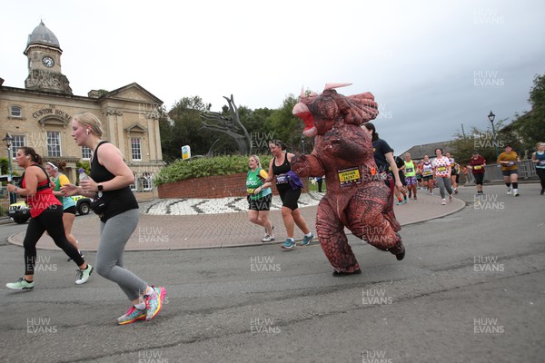 011023 - Principality Building Society Cardiff Half Marathon 2023 - Runner dressed as dinosaur at the Cardiff Barrage