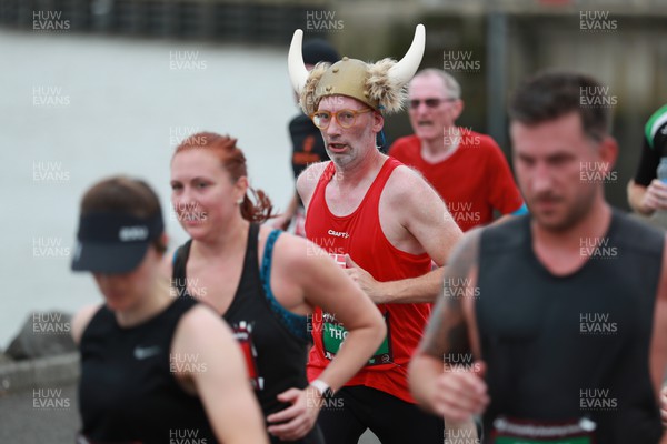 011023 - Principality Building Society Cardiff Half Marathon 2023 - Runner in viking helmet at the Cardiff Barrage