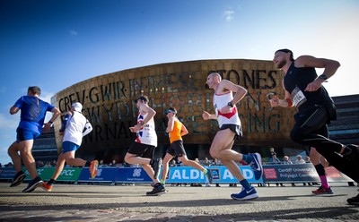 061019 - Cardiff Half Marathon 2019 - Runners make their way through Cardiff Bay, Roald Dahl Plas and past the Wales Millennium Centre at the halfway point of the race