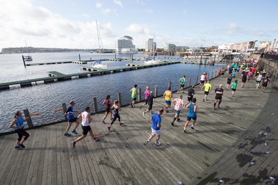 061019 - Cardiff Half Marathon 2019 - Runners make their way through Cardiff Bay, Roald Dahl Plas and past the Wales Millennium Centre at the halfway point of the race