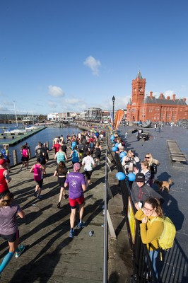 061019 - Cardiff Half Marathon 2019 - Runners make their way through Cardiff Bay, Roald Dahl Plas and past the Wales Millennium Centre at the halfway point of the race