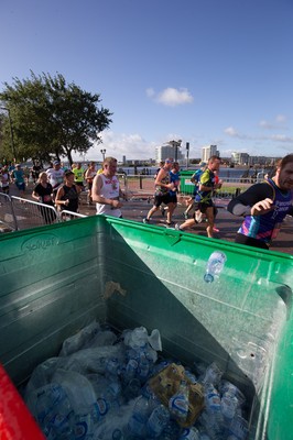 061019 - Cardiff Half Marathon 2019 - Runners recycle their water bottles as they make their way through Cardiff Bay, Roald Dahl Plas and past the Wales Millennium Centre at the halfway point of the race