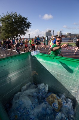 061019 - Cardiff Half Marathon 2019 - Runners recycle their water bottles as they make their way through Cardiff Bay, Roald Dahl Plas and past the Wales Millennium Centre at the halfway point of the race