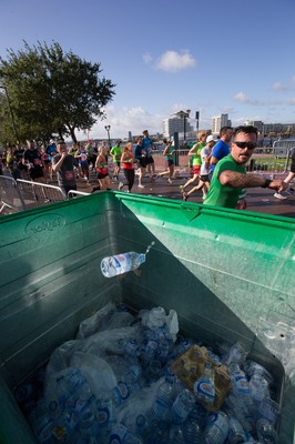 061019 - Cardiff Half Marathon 2019 - Runners recycle their water bottles as they make their way through Cardiff Bay, Roald Dahl Plas and past the Wales Millennium Centre at the halfway point of the race