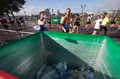 061019 - Cardiff Half Marathon 2019 - Runners recycle their water bottles as they make their way through Cardiff Bay, Roald Dahl Plas and past the Wales Millennium Centre at the halfway point of the race