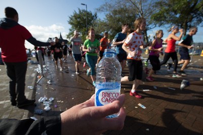 061019 - Cardiff Half Marathon 2019 - Runners recycle their water bottles as they make their way through Cardiff Bay, Roald Dahl Plas and past the Wales Millennium Centre at the halfway point of the race