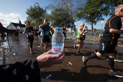 061019 - Cardiff Half Marathon 2019 - Runners recycle their water bottles as they make their way through Cardiff Bay, Roald Dahl Plas and past the Wales Millennium Centre at the halfway point of the race