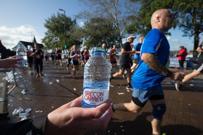 061019 - Cardiff Half Marathon 2019 - Runners recycle their water bottles as they make their way through Cardiff Bay, Roald Dahl Plas and past the Wales Millennium Centre at the halfway point of the race