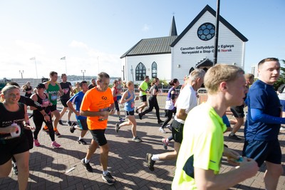 061019 - Cardiff Half Marathon 2019 - Runners make their way through Cardiff Bay, Roald Dahl Plas and past the Wales Millennium Centre at the halfway point of the race