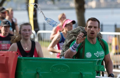 061019 - Cardiff Half Marathon 2019 - Runners recycle their water bottles as they make their way through Cardiff Bay, Roald Dahl Plas and past the Wales Millennium Centre at the halfway point of the race