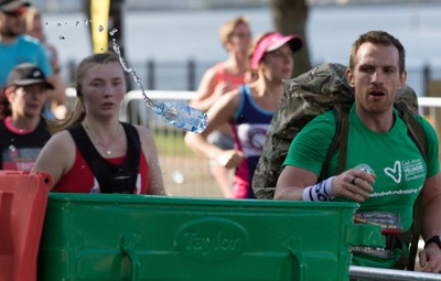 061019 - Cardiff Half Marathon 2019 - Runners recycle their water bottles as they make their way through Cardiff Bay, Roald Dahl Plas and past the Wales Millennium Centre at the halfway point of the race