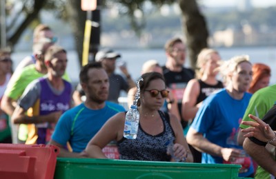 061019 - Cardiff Half Marathon 2019 - Runners recycle their water bottles as they make their way through Cardiff Bay, Roald Dahl Plas and past the Wales Millennium Centre at the halfway point of the race