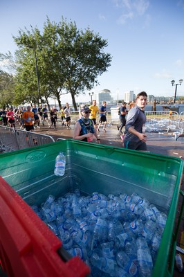 061019 - Cardiff Half Marathon 2019 - Runners recycle their water bottles as they make their way through Cardiff Bay, Roald Dahl Plas and past the Wales Millennium Centre at the halfway point of the race