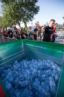 061019 - Cardiff Half Marathon 2019 - Runners recycle their water bottles as they make their way through Cardiff Bay, Roald Dahl Plas and past the Wales Millennium Centre at the halfway point of the race