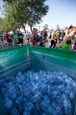 061019 - Cardiff Half Marathon 2019 - Runners recycle their water bottles as they make their way through Cardiff Bay, Roald Dahl Plas and past the Wales Millennium Centre at the halfway point of the race