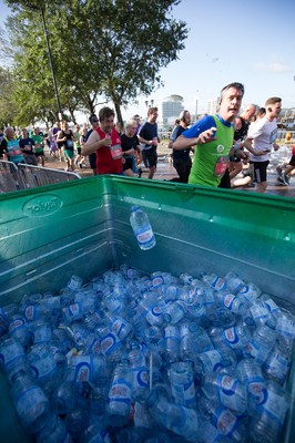 061019 - Cardiff Half Marathon 2019 - Runners recycle their water bottles as they make their way through Cardiff Bay, Roald Dahl Plas and past the Wales Millennium Centre at the halfway point of the race