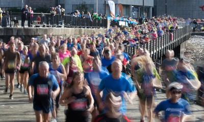 061019 - Cardiff Half Marathon 2019 - Runners make their way through Cardiff Bay, Roald Dahl Plas and past the Wales Millennium Centre at the halfway point of the race