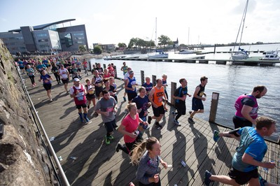 061019 - Cardiff Half Marathon 2019 - Runners make their way through Cardiff Bay, Roald Dahl Plas and past the Wales Millennium Centre at the halfway point of the race