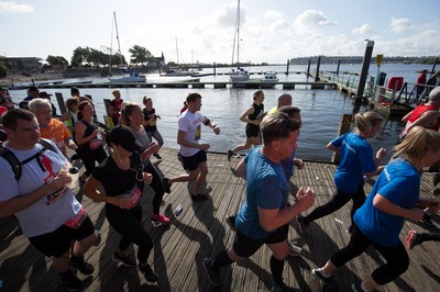 061019 - Cardiff Half Marathon 2019 - Runners make their way through Cardiff Bay, Roald Dahl Plas and past the Wales Millennium Centre at the halfway point of the race