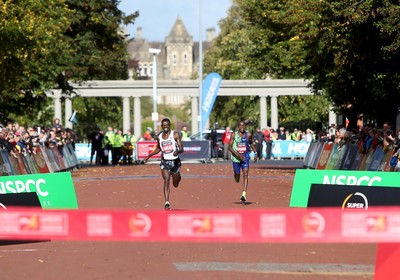 061019 - Cardiff Half Marathon -   Men's winner Leonard Langat crosses the line ahead of second placed Shadrack Kimining