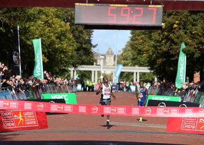 061019 - Cardiff Half Marathon -   Men's winner Leonard Langat crosses the line ahead of second placed Shadrack Kimining