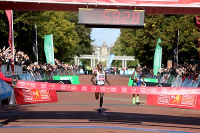 061019 - Cardiff Half Marathon -   Men's winner Leonard Langat crosses the line ahead of second placed Shadrack Kimining