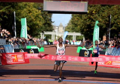 061019 - Cardiff Half Marathon -   Men's winner Leonard Langat crosses the line ahead of second placed Shadrack Kimining