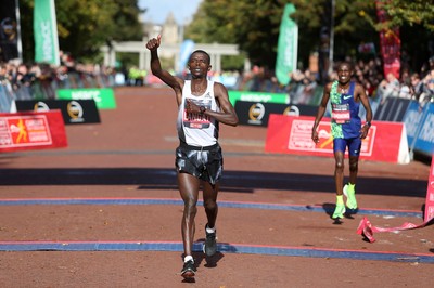 061019 - Cardiff Half Marathon -   Men's winner Leonard Langat crosses the line ahead of second placed Shadrack Kimining