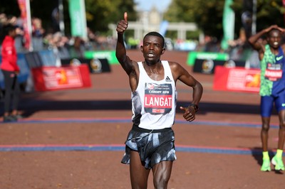 061019 - Cardiff Half Marathon -   Men's winner Leonard Langat crosses the line ahead of second placed Shadrack Kimining