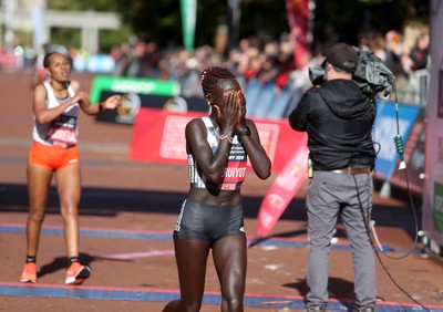 061019 - Cardiff Half Marathon -   Women's winner Lucy Cheruiyot crosses the line ahead of second placed Azmera Abreha