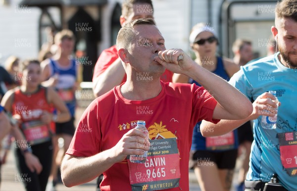 061019 - Cardiff Half Marathon 2019 - Runners recycle their water bottles as they make their way through Cardiff Bay, Roald Dahl Plas and past the Wales Millennium Centre at the halfway point of the race