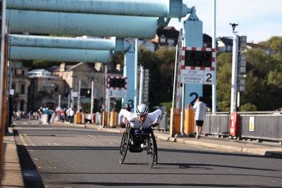 041026 - 2026 Cardiff Half Marathon - Wheelchair athletes cross  the Cardiff Bay Barrage 