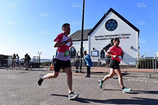 270322 - Cardiff University Cardiff Half Marathon - Runners pass the Norwegian Church in Cardiff Bay