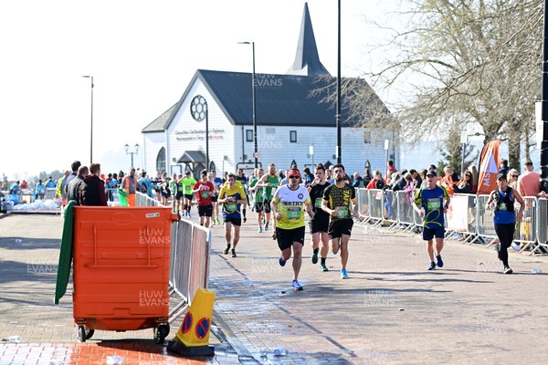 270322 - Cardiff University Cardiff Half Marathon - Runners pass the Norwegian Church in Cardiff Bay