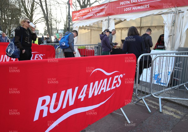 270322 - Cardiff University Cardiff Half Marathon - Participants gather at the various companies and charities in the runners village ahead of the start of the race