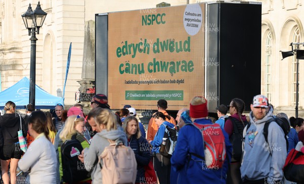 270322 - Cardiff University Cardiff Half Marathon - NSPCC advert on the big screen in the runners village ahead of the start of the race