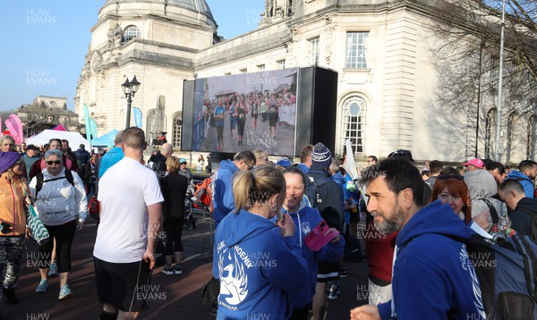 270322 - Cardiff University Cardiff Half Marathon - The big screen in the runners village ahead of the start of the race