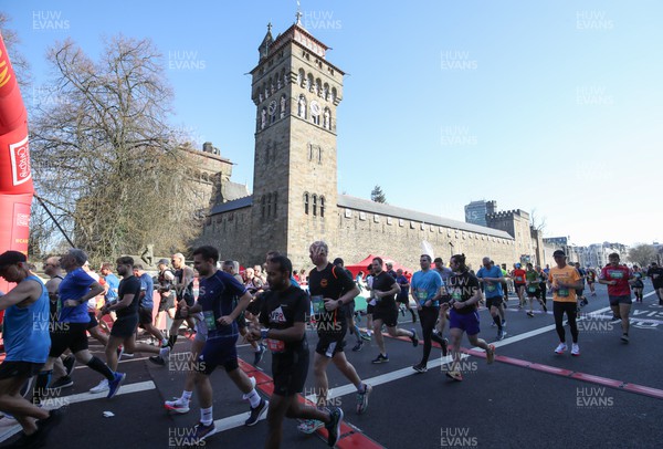 270322 - Cardiff University Cardiff Half Marathon - Runners set off from the start line outside Cardiff Castle