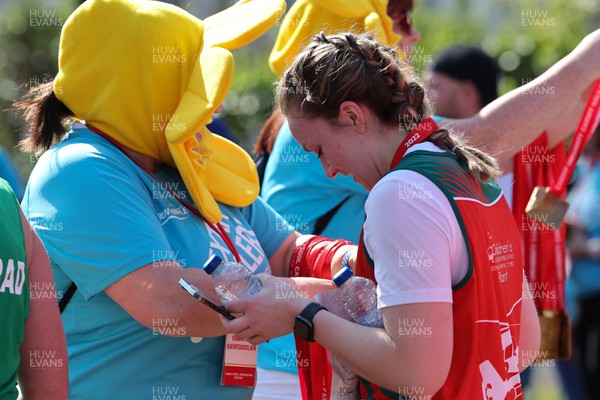 270322 - Cardiff University Cardiff Half Marathon - Finishers medals are handed out at the end of the race