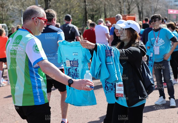 270322 - Cardiff University Cardiff Half Marathon - Finishers T Shirts are handed out at the end of the race